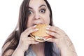 Overweight woman with appetite greedily eats hamburger. Obesity and fast food. Isolated on white background. Close-up Royalty Free Stock Photo
