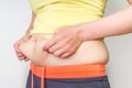 Overweight woman body with hands touching belly fat Royalty Free Stock Photo