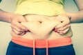 Overweight woman body with hands touching belly fat Royalty Free Stock Photo