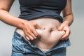 Overweight woman body with hands touching belly fat Royalty Free Stock Photo