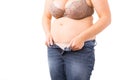 Overweight woman can`t close her jeans