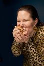 Overweight woman does not eat hamburger appetizingly. Overweight.