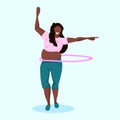 Overweight woman doing gymnastic rotating workout with hula hoop african american girl weight loss concept full length Royalty Free Stock Photo
