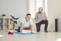 Overweight woman doing a plank with a leg raise during a sports workout with her trainer Royalty Free Stock Photo