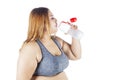 Overweight woman drinks water after workout Royalty Free Stock Photo