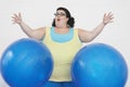 Overweight Woman Dropping Two Exercise Balls