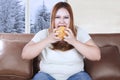 Overweight woman eats hamburger Royalty Free Stock Photo