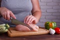 Overweight woman hands chopping up chicken breasts. Dieting, hea Royalty Free Stock Photo