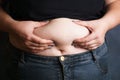 Overweight woman hands touching belly fat Royalty Free Stock Photo