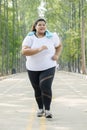 Overweight woman jogging on the road Royalty Free Stock Photo