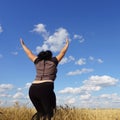 Overweight woman jumping at sky background
