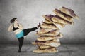 Overweight woman kicking stack of pizza Royalty Free Stock Photo