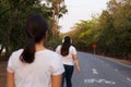 Overweight woman listen to music while walking in the park.