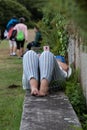 Overweight woman lying on bench park looking at her phone Royalty Free Stock Photo