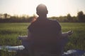 Overweight woman meditating in sunlight