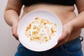 Overweight woman overeating. Word Fat on dirty plate. Food addic Royalty Free Stock Photo