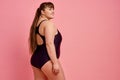 Overweight woman poses in swimsuit, body positive