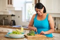 Overweight Woman Preparing Vegetables In Kitchen Royalty Free Stock Photo