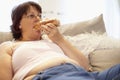 Overweight Woman Relaxing On Sofa Royalty Free Stock Photo