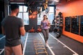 Overweight woman running in gym smiling to her trainer Royalty Free Stock Photo