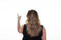 Overweight woman standing behind pointing to side object on white empty copy space rear view Royalty Free Stock Photo