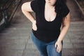 Overweight woman suffering from breathe shortness stepping on st