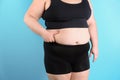 Overweight woman touching belly fat before weight loss Royalty Free Stock Photo