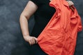 Overweight woman trying new blouse on. Plus size, inconvenience Royalty Free Stock Photo