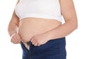 Overweight woman trying to wear tight jeans Royalty Free Stock Photo