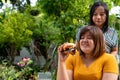 The overweight woman is in a wheelchair. Being eating a burger in which but her friend is not happy because of concern for the Royalty Free Stock Photo