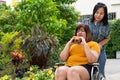 The overweight woman is in a wheelchair. Being eating a burger in which but her friend is not happy because of concern for the Royalty Free Stock Photo
