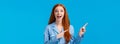 Overwhelmed amused pretty redhead teen girl in nightwear screaming excited and amazed, pointing upper left corner, drop Royalty Free Stock Photo