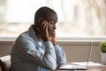 Overwhelmed exhausted young african american guy suffering from headache. Royalty Free Stock Photo