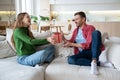 Loving smiling woman congratulating cheerful happy man with birthday, giving present in festive box