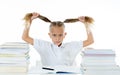 Overwhelmed little girl with a negative attitude towards studies and school after studying too much and having too many homework Royalty Free Stock Photo