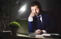 Overwork. Businessman working on laptop in office