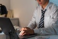 Overwork Concept The man sitting at his desk and focusing on working through his computer laptop Royalty Free Stock Photo