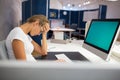 Exhausted businesswoman having a headache at office