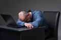 Overworked businessman asleep on laptop Royalty Free Stock Photo