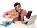 Overworked businessman busy at office desk working on computer mobile phone and digital tablet asking for help Royalty Free Stock Photo