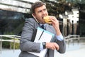 Overworked businessman eating fast food on the go Royalty Free Stock Photo