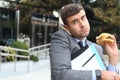 Overworked businessman eating fast food on the go Royalty Free Stock Photo