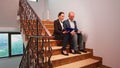 Overworked businessman reading raport on stairs