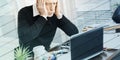 Overworked businessman sitting at a messy desk, geometric pattern Royalty Free Stock Photo