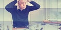 Overworked businessman sitting at a messy desk, geometric pattern Royalty Free Stock Photo