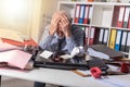 Overworked businessman sitting at a messy desk, light effect Royalty Free Stock Photo