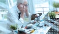 Overworked businessman sitting at a messy desk  light effect Royalty Free Stock Photo