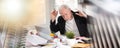 Overworked businessman sitting at a messy desk  multiple exposure Royalty Free Stock Photo