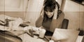 Overworked businesswoman sitting at a messy desk, geometric pattern Royalty Free Stock Photo