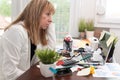 Overworked businesswoman sitting at a messy desk Royalty Free Stock Photo